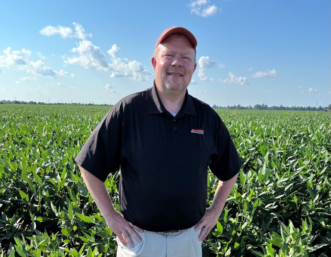 Davis standing in the field his parents purchased the year he was born 