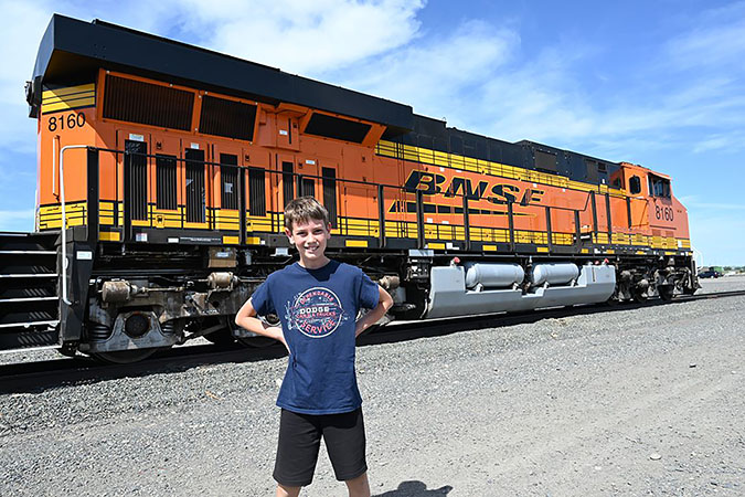 Jacob Meissner standing in front of a BNSF locomotive